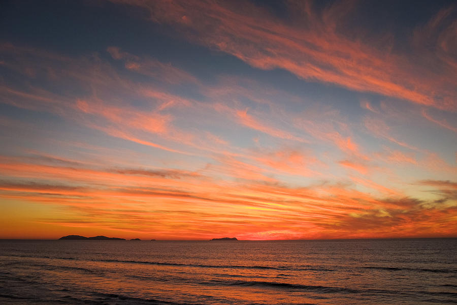 A cloudy and colorful sunset on the Pacific Coast of Mexico Photograph by Photo Beto