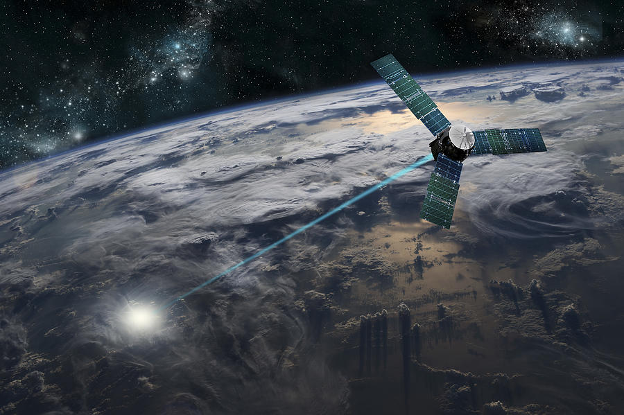A composite image of a satellite firing an energy weapon at a target on Earth. Drawing by Marc Ward/Stocktrek Images