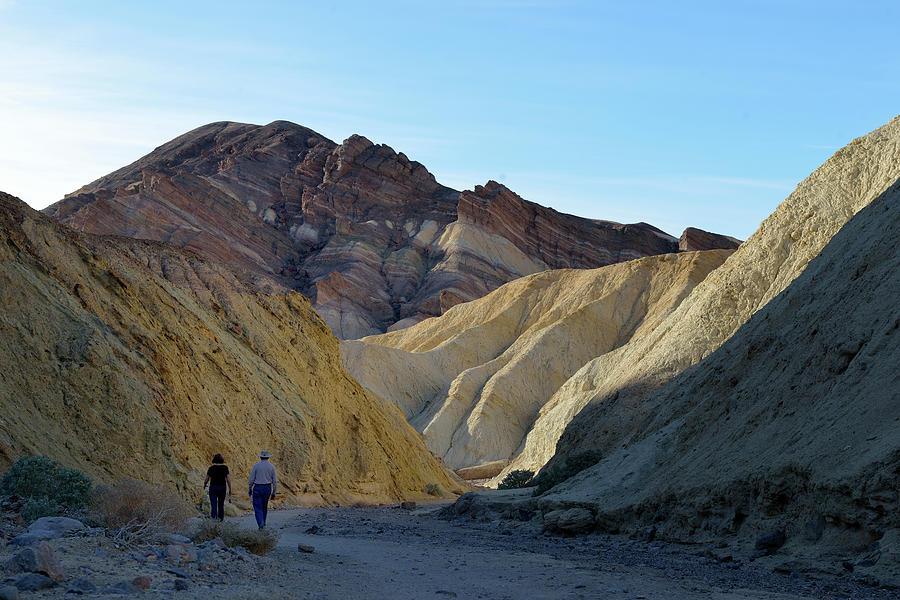 A couple walking in Golden Canyon,  Death Valley, California Photograph by Kevin Oke