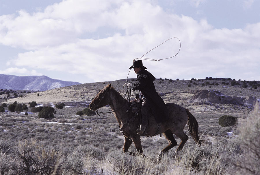 A Cowboy Rides His Horse Photograph by Photodisc