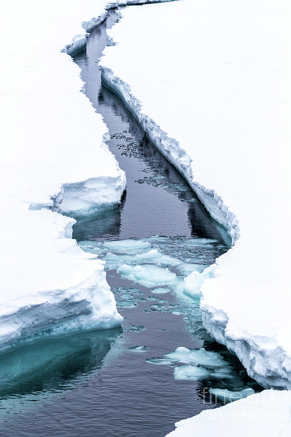 A crack in the ice. The ice shelf opens up as an icebreaker ship passes through. Svalbard, a Norwegian archipelago between mainland Norway and the North Pole and in the arctic circle Photograph by Jane Rix