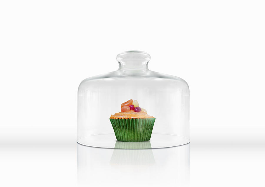 A cupcake under a glass cloche Photograph by Luxx Images