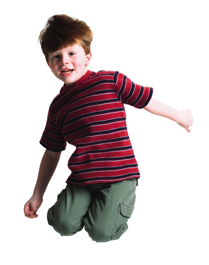 A Cute Littel Redheaded Boy Jumps Up High Into The Air And Tuck His Legs Behind Him Photograph by Photodisc
