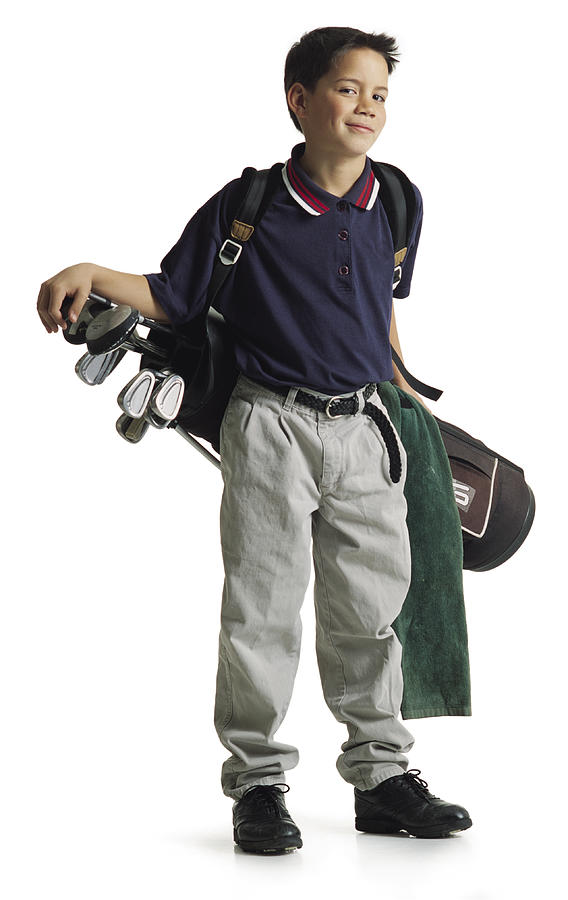 A Cute Polynesian Boy Stands Smiling With His Bag Of Golf Clubs Hanging On His Shoulder Behind Him Photograph by Photodisc