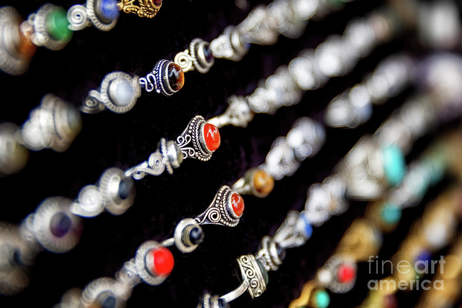 A display of generic silver rings set with semi-precious stones, on a black velvet background. Vintage style craft jewelery Photograph by Jane Rix