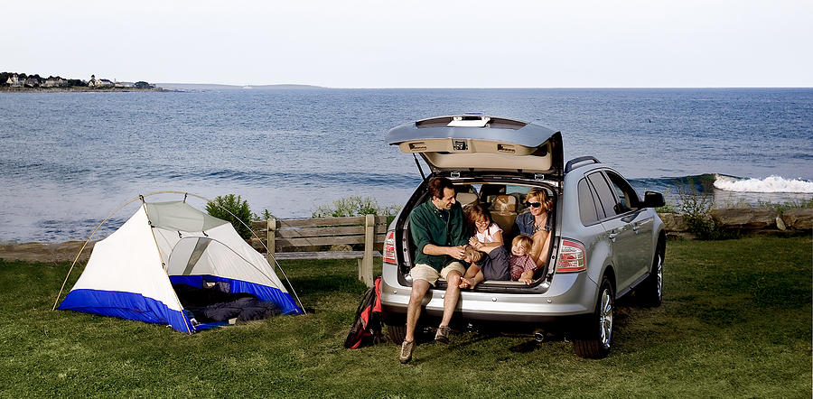 A family sitting in the back of an SUV outdoors Photograph by JudsonAbts