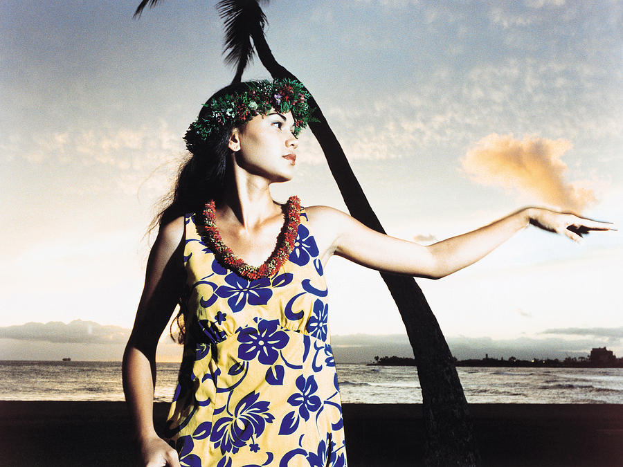 A female hula dancing outdoors near the ocean at sunset Photograph by Dex Image