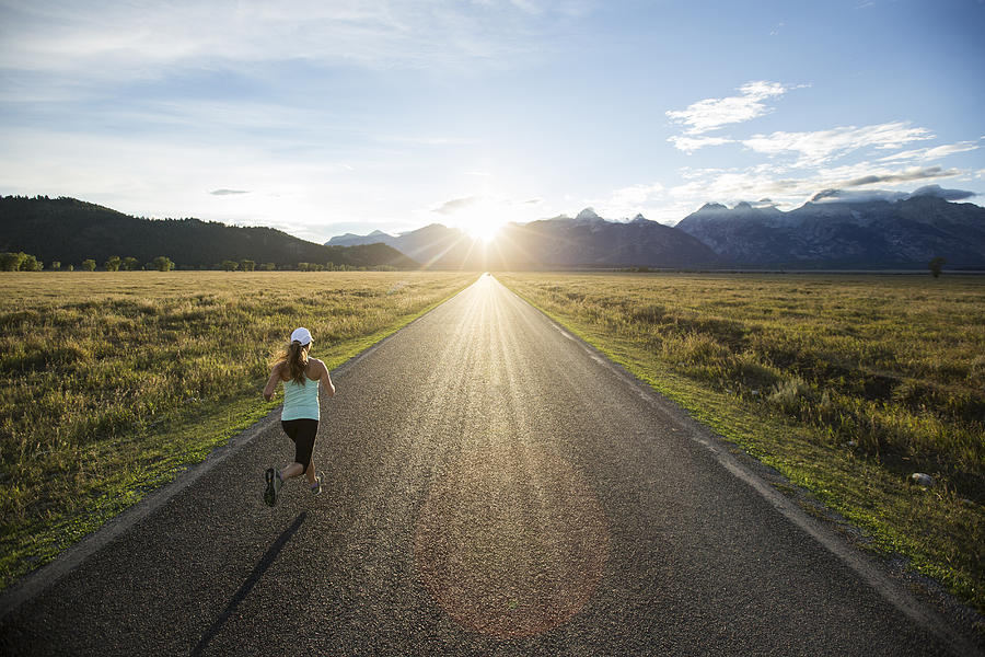 A female running at sunset. Photograph by Jordan Siemens