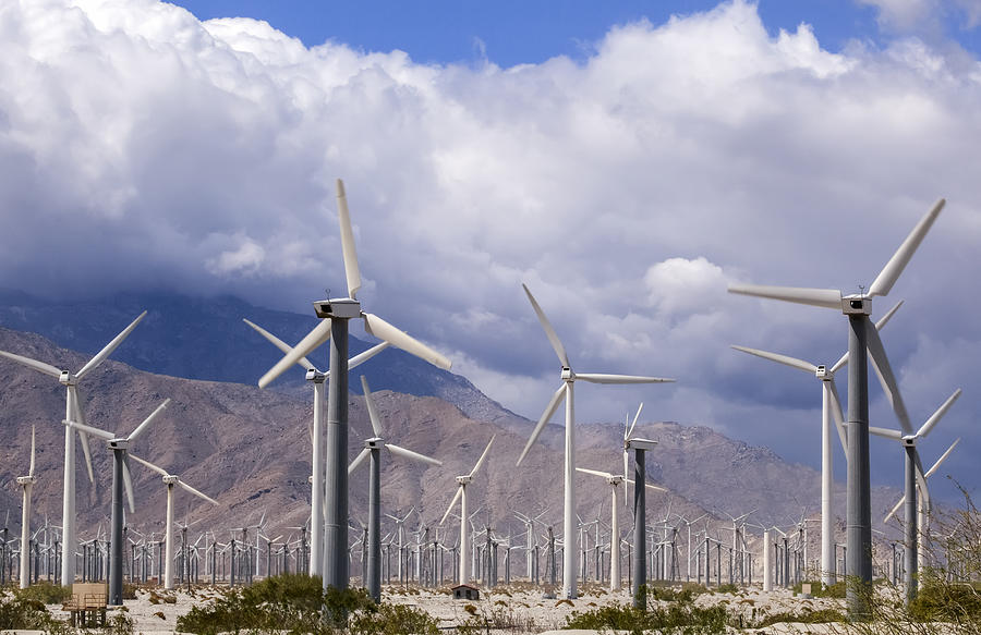 A field of wind generators with mountains and clouds in the background, a common sight in California Photograph by Timothy Hearsum / Design Pics