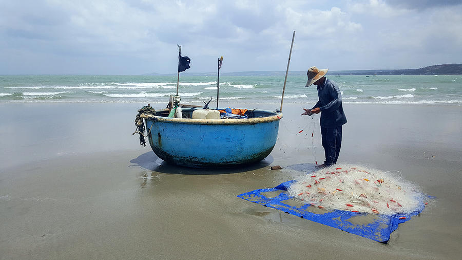 A fisherman on the beach of Mui né, Vietnam Photograph by Frans Sellies