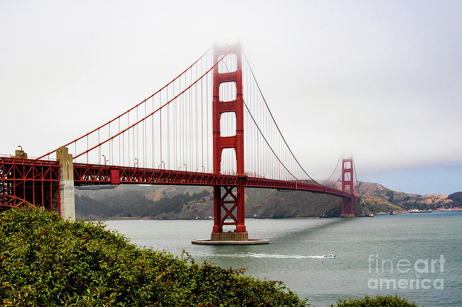 A foggy morning at San Franciscos Golden Gate Bridge.  Photograph by Gunther Allen