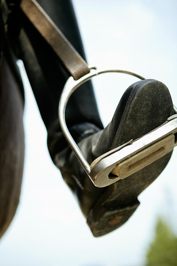 A foot in a stirrup Photograph by Image Source