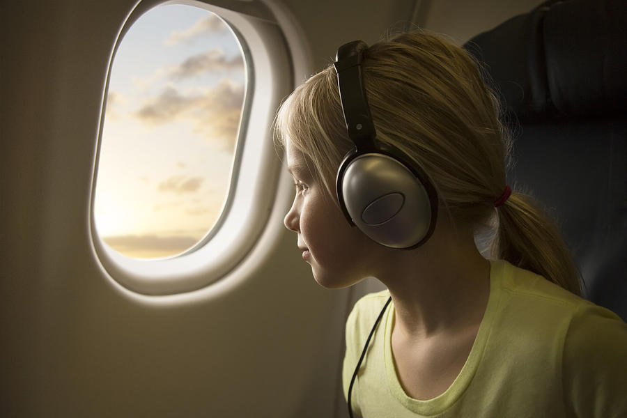 A Girl In An Airplane Looking Out Of The Window Photograph by Per Breiehagen