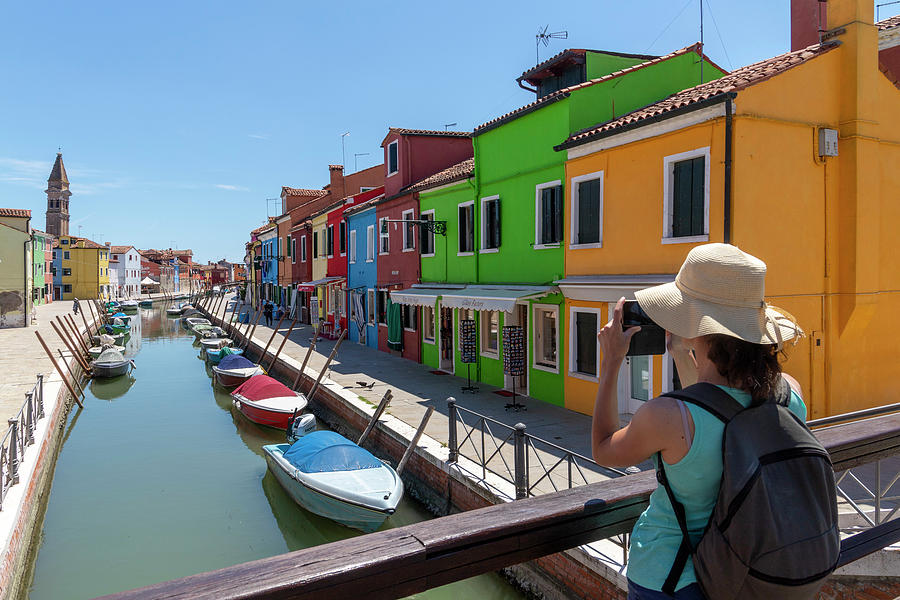 A girl taking a photo in Burano Photograph by Pietro Ebner