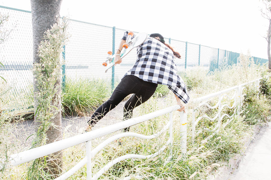 A girl who jumps over the fence Photograph by Yusuke Nishizawa