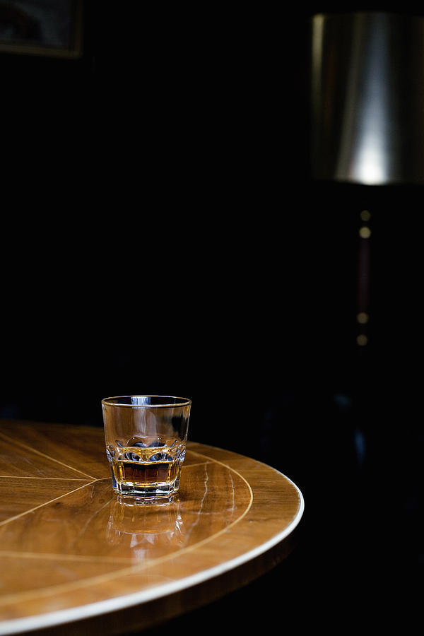A glass of whiskey on a table Photograph by Andreas Schlegel