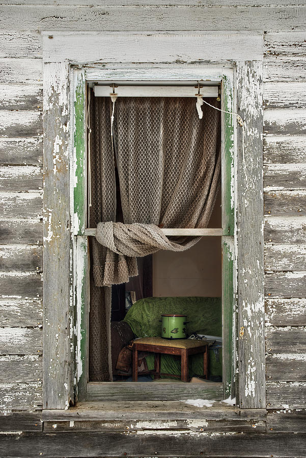 A Glimpse Back -  view through broken window of abandoned ND farmstead Photograph by Peter Herman