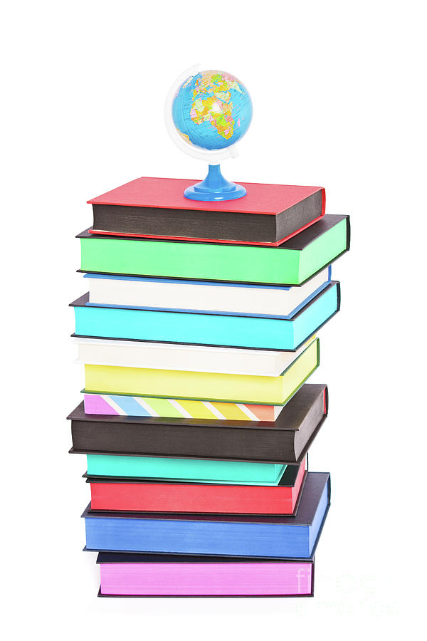 A globe on top of stack of colorful books Photograph by Mendelex Photography