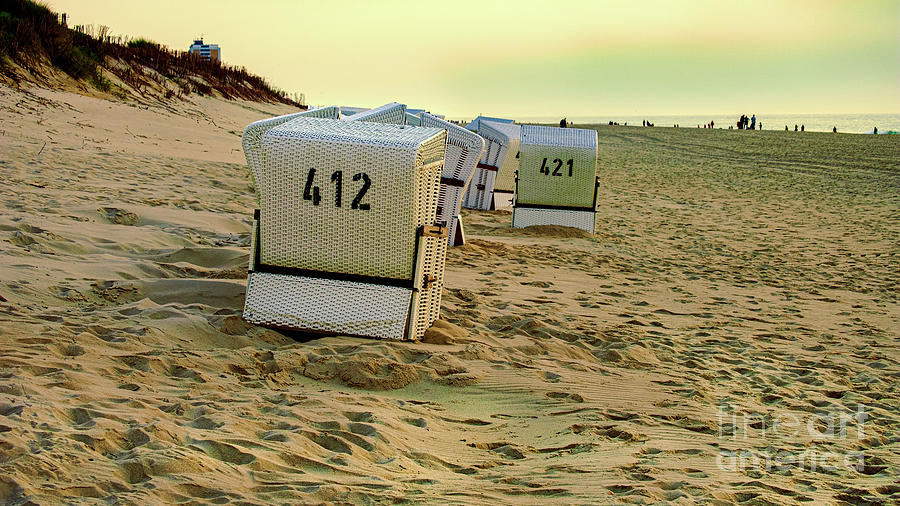 A Group Of Beach Cabins At Sunset Photograph