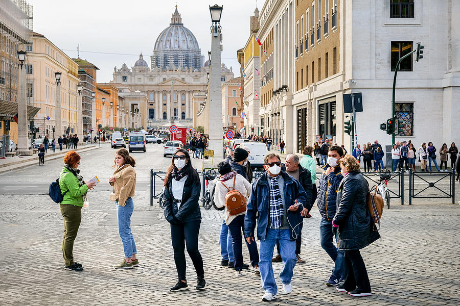 A group of tourists with medical masks on their mouths in St. Peters Square Photograph by Photo Beto