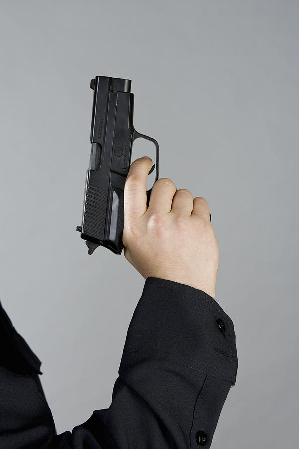 A hand holding a gun Photograph by Halfdark