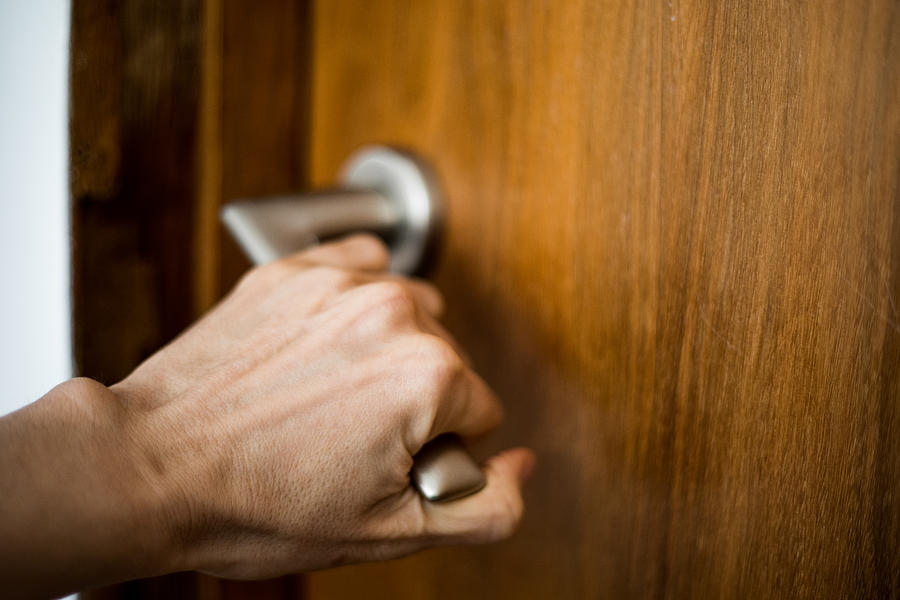 A hand holding the doorknob, opening / closing a door Photograph by Photographer, Basak Gurbuz Derman
