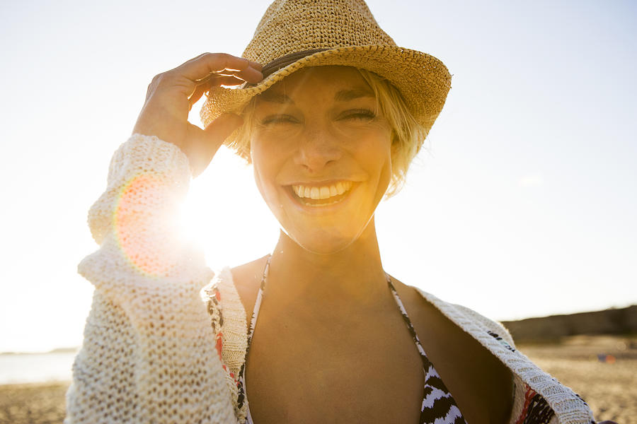 A happy woman at the beach. Photograph by Jordan Siemens