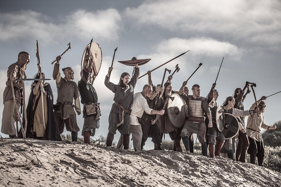 A hoard of Weapon wielding viking warriors on a sandy battlefield dune Photograph by Lorado