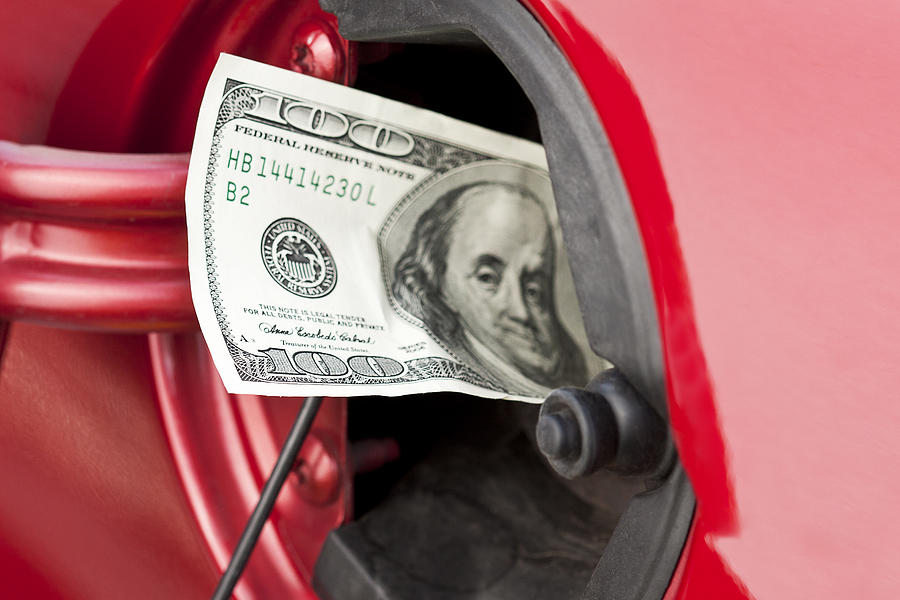 A hundred dollar bill stuffed into a cars gas tank Photograph by Patty_c