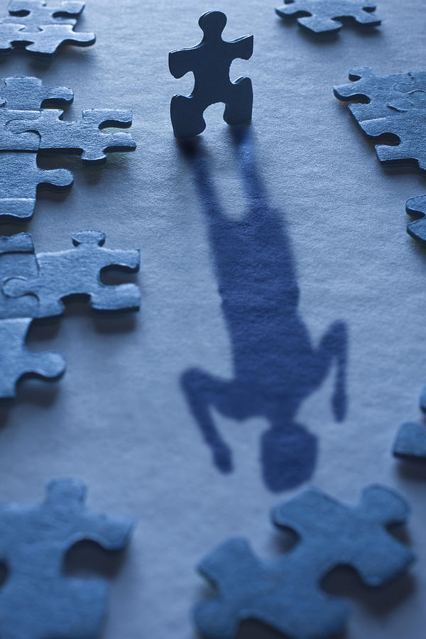 A jigsaw piece forms the shadow of a happy woman Photograph by Andrew Bret Wallis