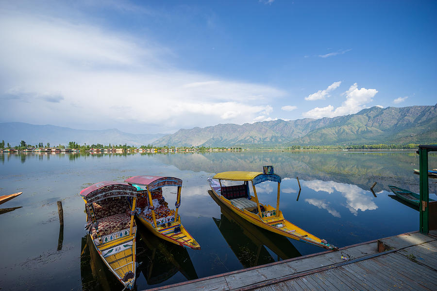 A Kashmiri man paddling a shikara (traditional boat) on Dal Lake of Kashmir, India. Photograph by Shaifulzamri