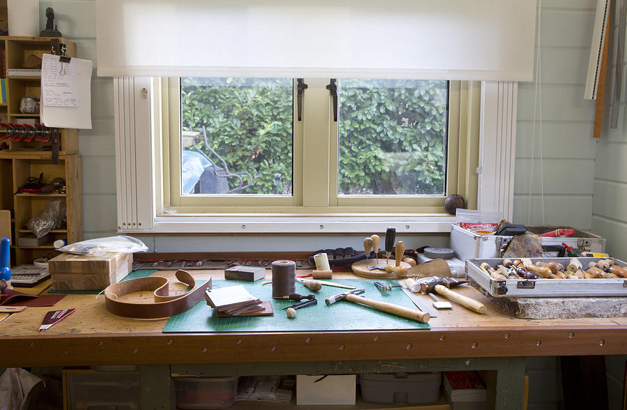 A leather stitchers work bench full of tools Photograph by Nicola Tree