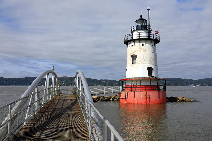 A lighthouse with a red base and a white tower in the Hudson River Photograph by Rainer Grosskopf