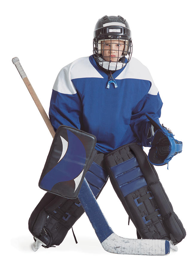 A Little Caucasian Boy Dressed In A Hockey Uniform Stands With Legs Apart Scowling Through His Goalie Mask Photograph by Photodisc