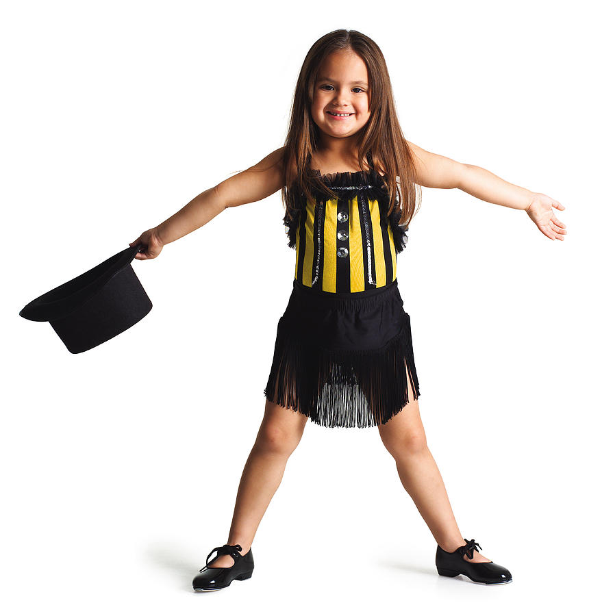 A Little Ethnic Girl In A Dance Outfit Spreads Her Arms Out And Smiles While Holding A Top Hat Photograph by Photodisc
