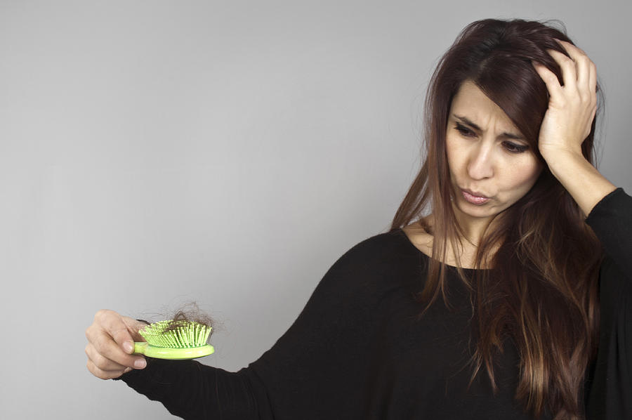 A long hair woman holding a green hairbrush full of hairs Photograph by Mehmet Hilmi Barcin