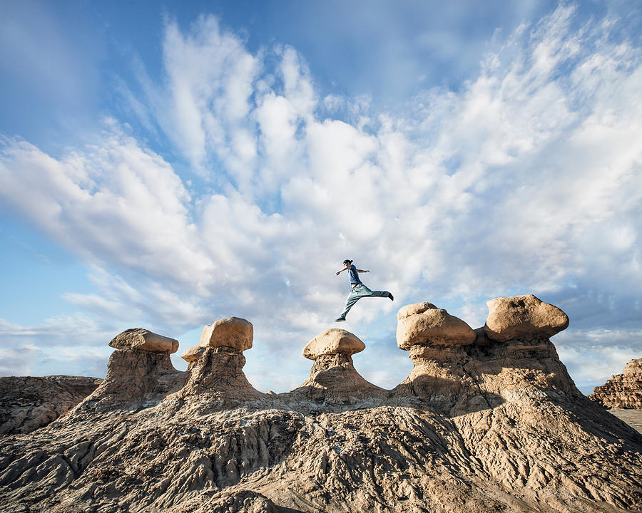 A man doing Parkour on rocks in the desert Photograph by Robb Reece