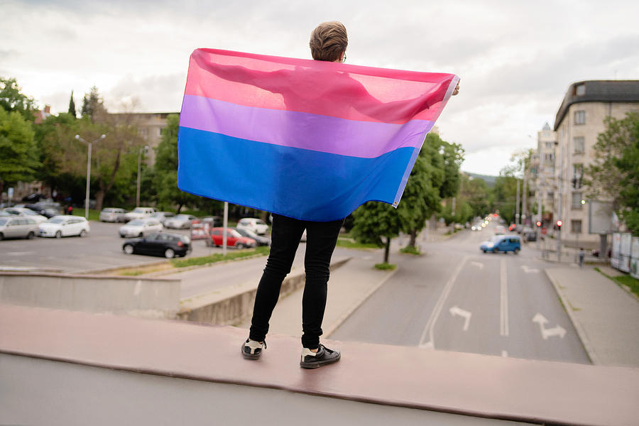 A man holding the lesbian flag to show his support Photograph by Vladimir Vladimirov