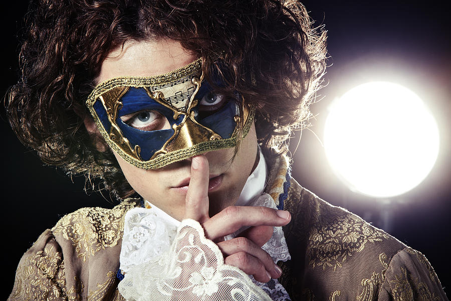 A man in a Venetian mask putting a finger to his mouth Photograph by Kparis