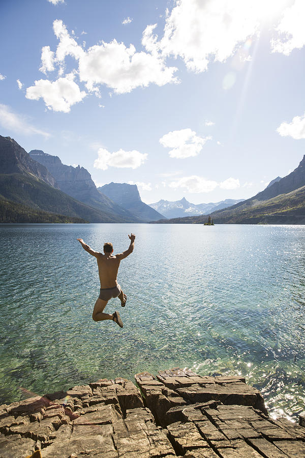 A man jumping into a lake Photograph by Jordan Siemens