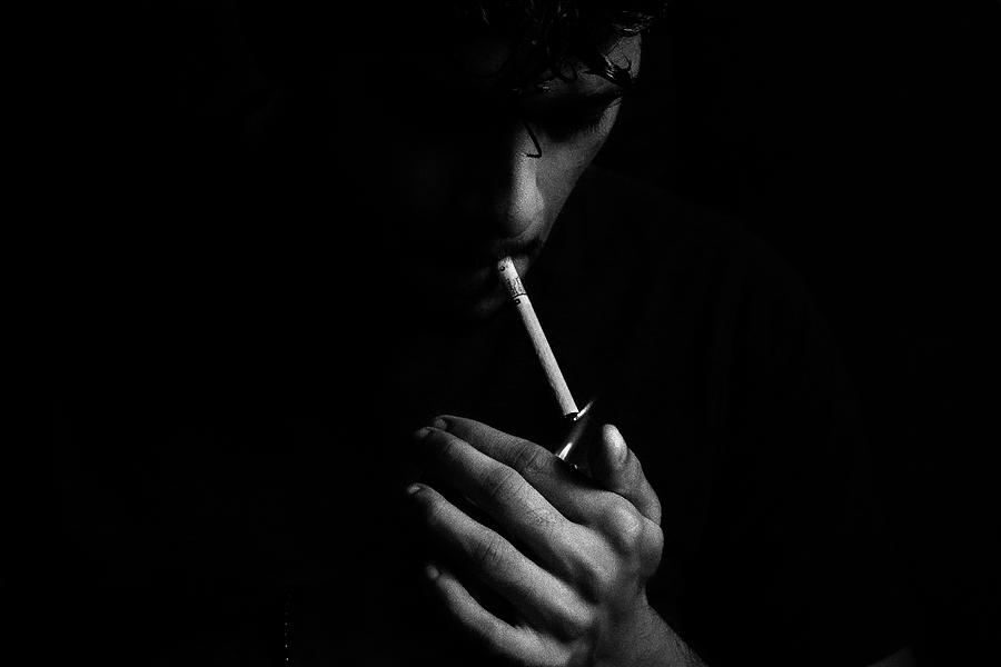 A man lighting up a cigarette. Photograph by Shivantha Silva - Fine Art ...