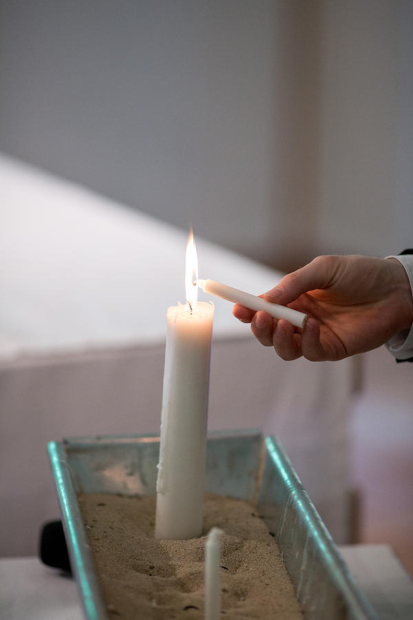 A Man Lights a Candle in a Church during a Wedding Ceremony in Berlin, Germany Summertime Photograph by Morten Falch Sortland
