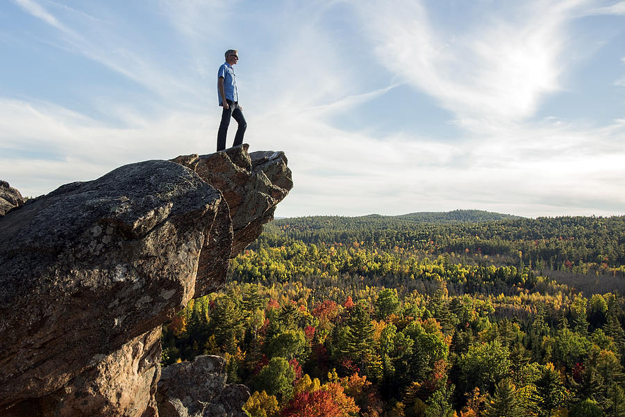 A man on the edge of a cliff. Photograph by Saffron Blaze