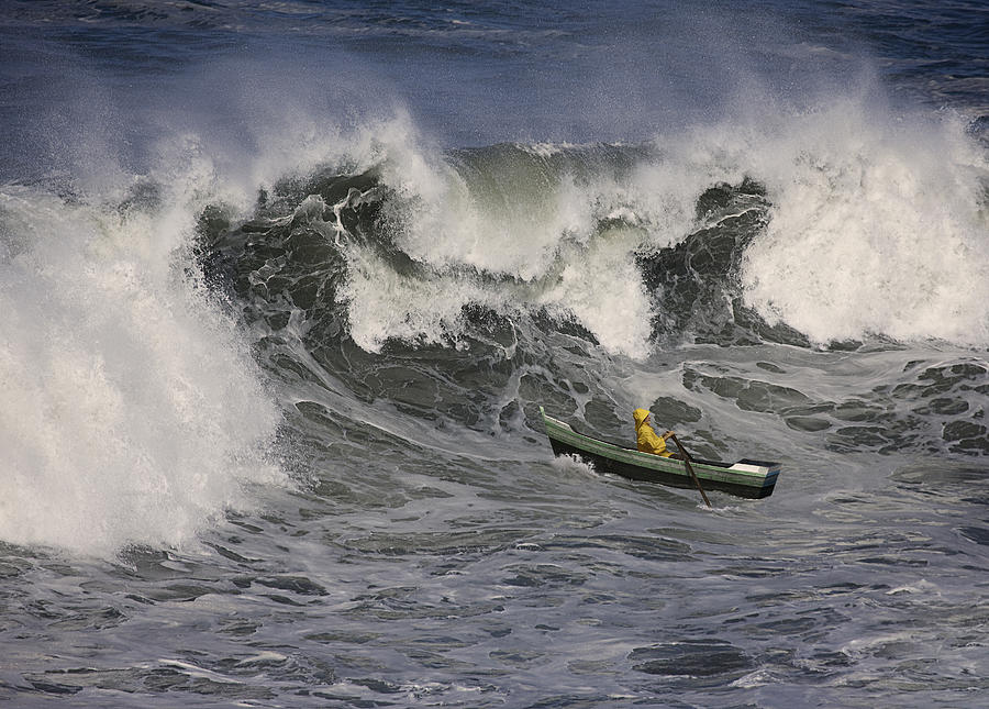 A Man Rows His Small Boat Up A Huge Wave Photograph by John Lund