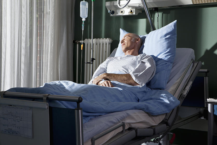 A man sleeping in a hospital bed Photograph by Halfdark