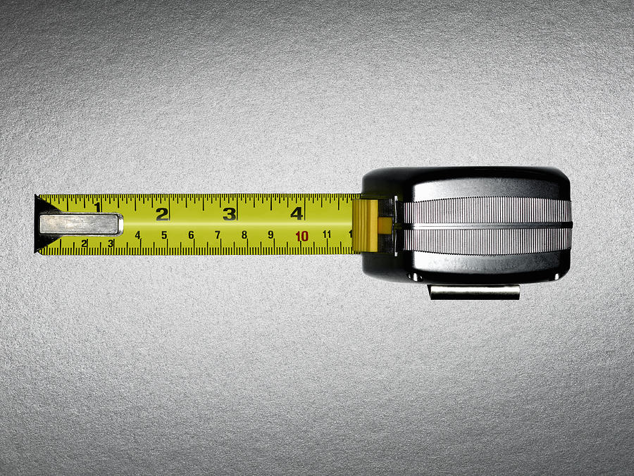 A measuring tape with five inches showing Photograph by Adam Gault