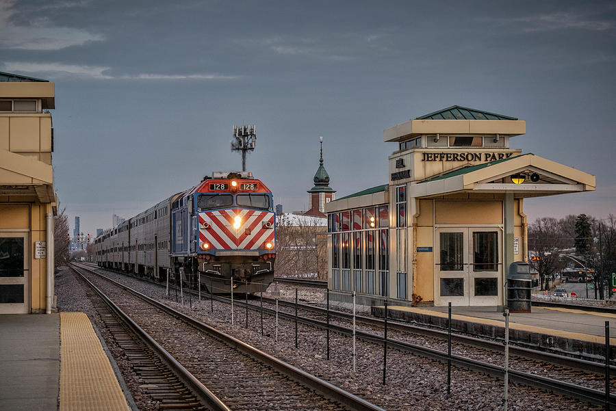 A Metra train arrives at Jefferson Park Chicago Illinois Photograph by Jim Pearson