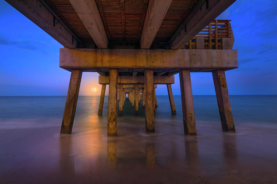 A Moonrise Under the Pier Photograph by Mark Andrew Thomas