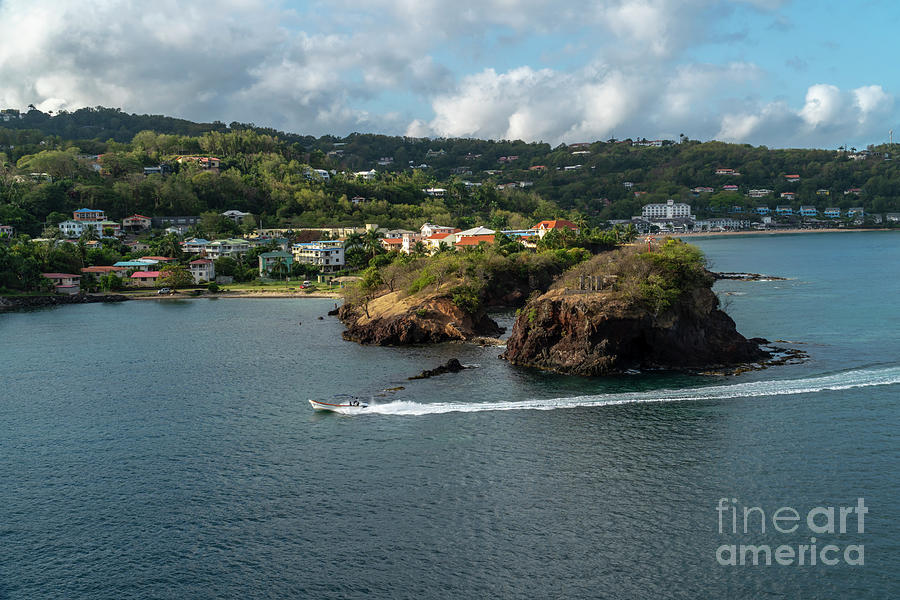 A motorboat cruises past Tapion Shoal at St Lucia in the Caribbean Photograph by William Kuta