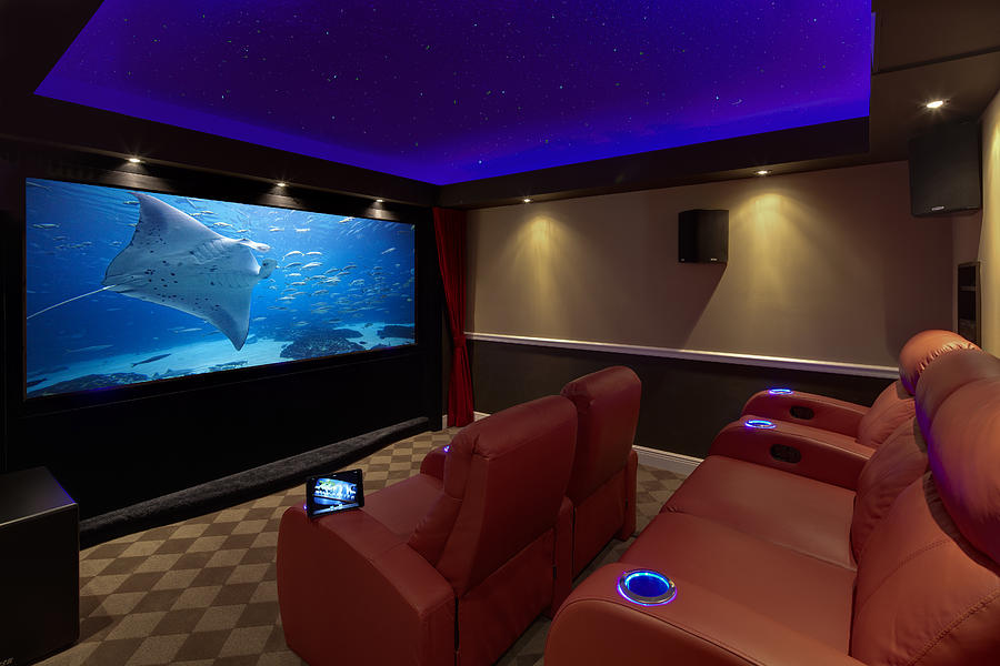 A Movie Plays On A High End Luxury Home Theater Sy Photograph by Dana Hoff